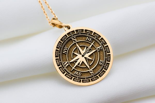 Solid gold compass pendant necklace, small and simple, symbolizing direction and inner strength. A timeless statement piece ideal for everyday wear, adding sophistication to any look. Great as a friendship or protection charm