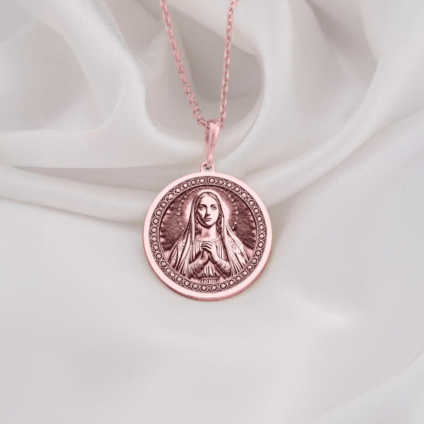 Graceful Rose Gold Plated Mary necklace featuring the Queen of Peace in prayer. A feminine and spiritual rose gold faith pendant.