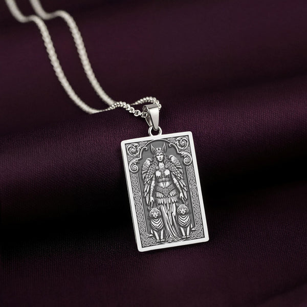 A handcrafted 925 sterling silver Freya charm in a rectangular tarot card shape. This personalized piece of Viking jewelry shows the goddess with her famous necklace, Brísingamen, and her cat companions, embodying the divine feminine.