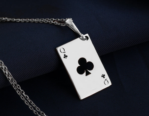Queen of Club solitaire gold necklace playing card. club symbols and the iconic "Q" in the top left and bottom right corners. the Queen of Clubs, a symbol often linked to intuition, creativity, and power in the world of playing cards.