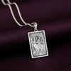 A striking 925 sterling silver tarot card pendant of the Goddess of the Hunt, Artemis. This piece of witchy jewelry is styled on a dark purple silk background.