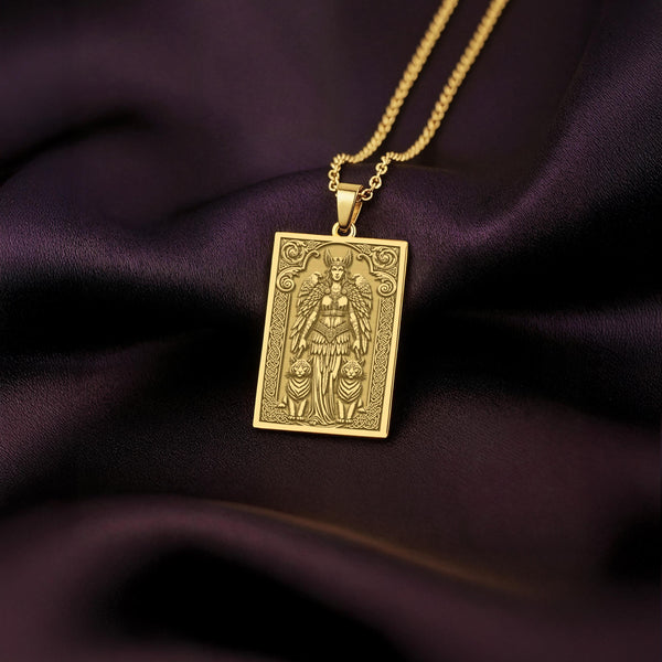 A handmade 14K gold plated rectangular tarot card necklace featuring a highly detailed engraving of the Norse Goddess Freya. The artwork shows the Viking goddess with her feathered cloak and the two sacred cats that pull her chariot, a powerful piece of Norse mythology jewelry.