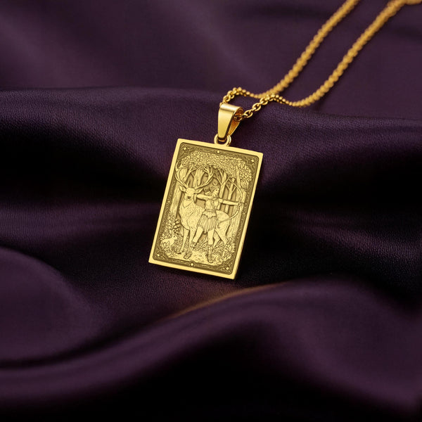 An heirloom-quality 14K solid gold tarot card amulet depicting the Moon Goddess Artemis and a stag. This fine engraved jewelry captures the cottagecore aesthetic.