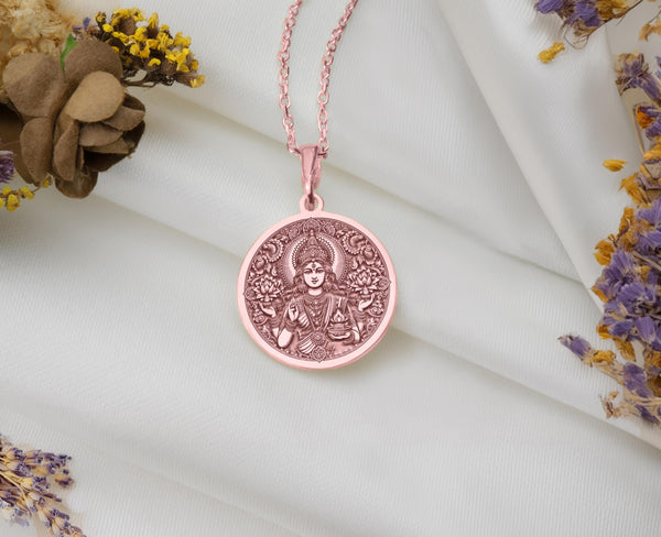 14k rose gold plated Lakshmi medallion. This pendant charm features the goddess of wealth, making it a meaningful talisman for prosperity. Perfectly paired with any chain, this amulet adds both elegance and spiritual depth to your jewelry collection