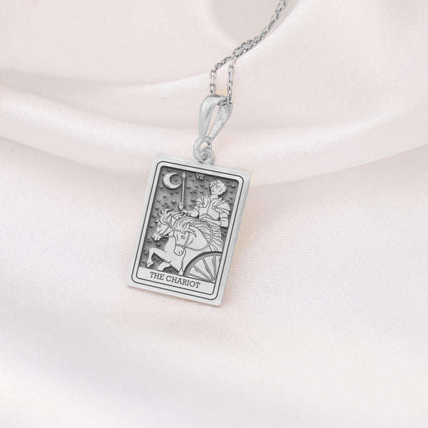The Silver Chariot Necklace is a beautifully crafted piece made from 925K sterling silver, featuring a detailed tarot charm design. Perfect for tarot enthusiasts, spiritual seekers, or anyone looking for a unique gift, this necklace combines elegance and meaning. It comes with a spring ring clasp, ensuring durability and a luxurious finish. Embrace the energy of The Chariot tarot card with this meaningful jewelry piece, ideal for daily wear or special occasions.