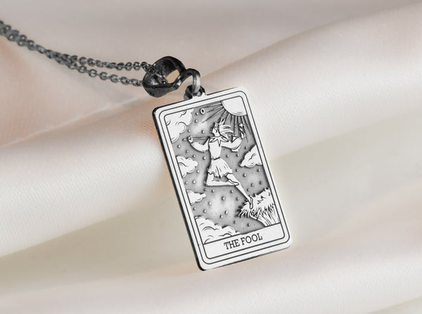 The Fool tarot card charm silver necklace featuring , an etched charm perfect for a personalized necklace. and ideal for everyday wear, this vintage inspired pendant is a unique protection amulet for those embracing hope and new journeys