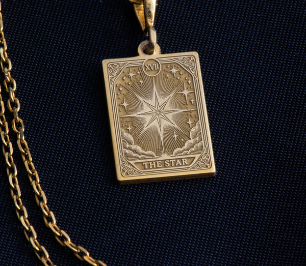 Luxurious 14K solid gold Star Tarot Card pendant necklace featuring intricate celestial engraving with eight-pointed star, customizable spiritual jewelry. The rectangular tarot card design shows detailed rays of light, moon phases, and mystical symbols surrounding the central star. Personalized esoteric gift for tarot enthusiasts, astrology lovers, and spiritual seekers. Premium handcrafted Major Arcana talisman with "THE STAR" inscription.