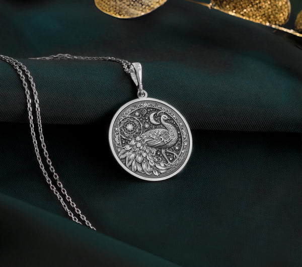 Detailed 925 Sterling Silver bird charm in peacock form, surrounded by stars and mandala patterns. A spiritual and graceful accessory.
