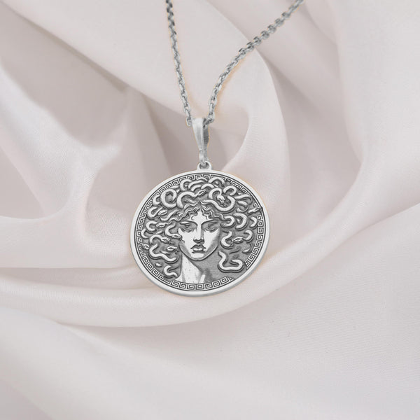 Silver Medusa Charm Necklace featuring the iconic gorgon head symbol. Perfect for lovers of mythology, gothic fashion, or unique statement pieces. Silver-plated, adjustable chain. Great gift for fans of Greek mythology and bold accessories