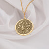 14k solid gold Shiva Parvati pendant necklace with intricate temple motifs, adorned with rubies and emerald accents on an adjustable chain