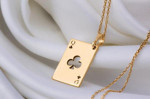 Queen of Club solitaire gold necklace playing card. club symbols and the iconic "Q" in the top left and bottom right corners. the Queen of Clubs, a symbol often linked to intuition, creativity, and power in the world of playing cards.