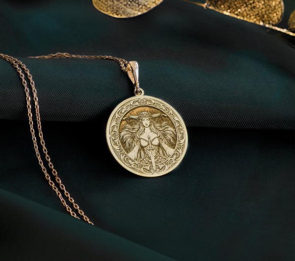 14K Gold Plated Morrigan Medallion with Celtic warrior symbolism. Powerful goddess pendant with crown, sacred sword and flowing hair. Elegant pagan jewelry gift representing battle magic, transformation and the fierce sovereignty of the crow deity.