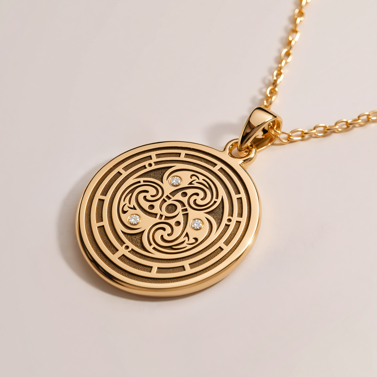 Round gold Flower of Life pendant with an engraved geometric pattern