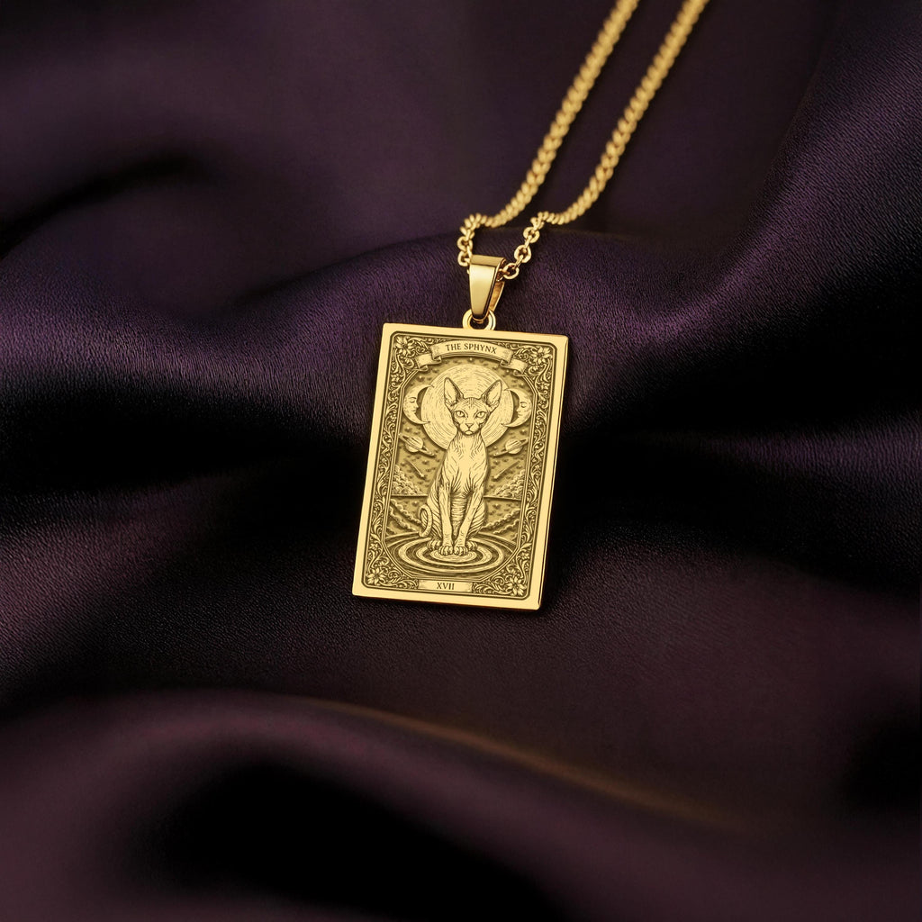 An heirloom-quality 14K solid gold Sphynx Cat tarot pendant. The art shows the regal cat, symbolizing its divine nature, a precious cat mom gift.