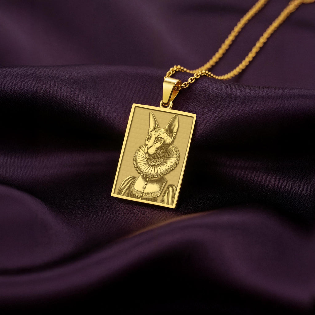 A rectangular 14K gold plated pendant necklace featuring a detailed laser engraving of a Sphynx cat queen in a Victorian ruff collar.