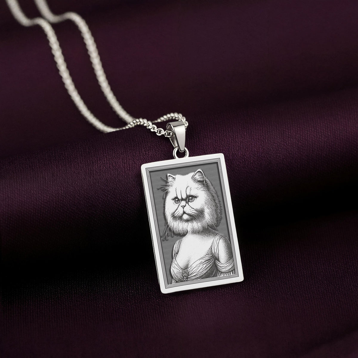 925 Sterling Silver version of The Ancestors Collection's Persian Cat necklace, with its cool silver tone beautifully contrasting the rich purple fabric.