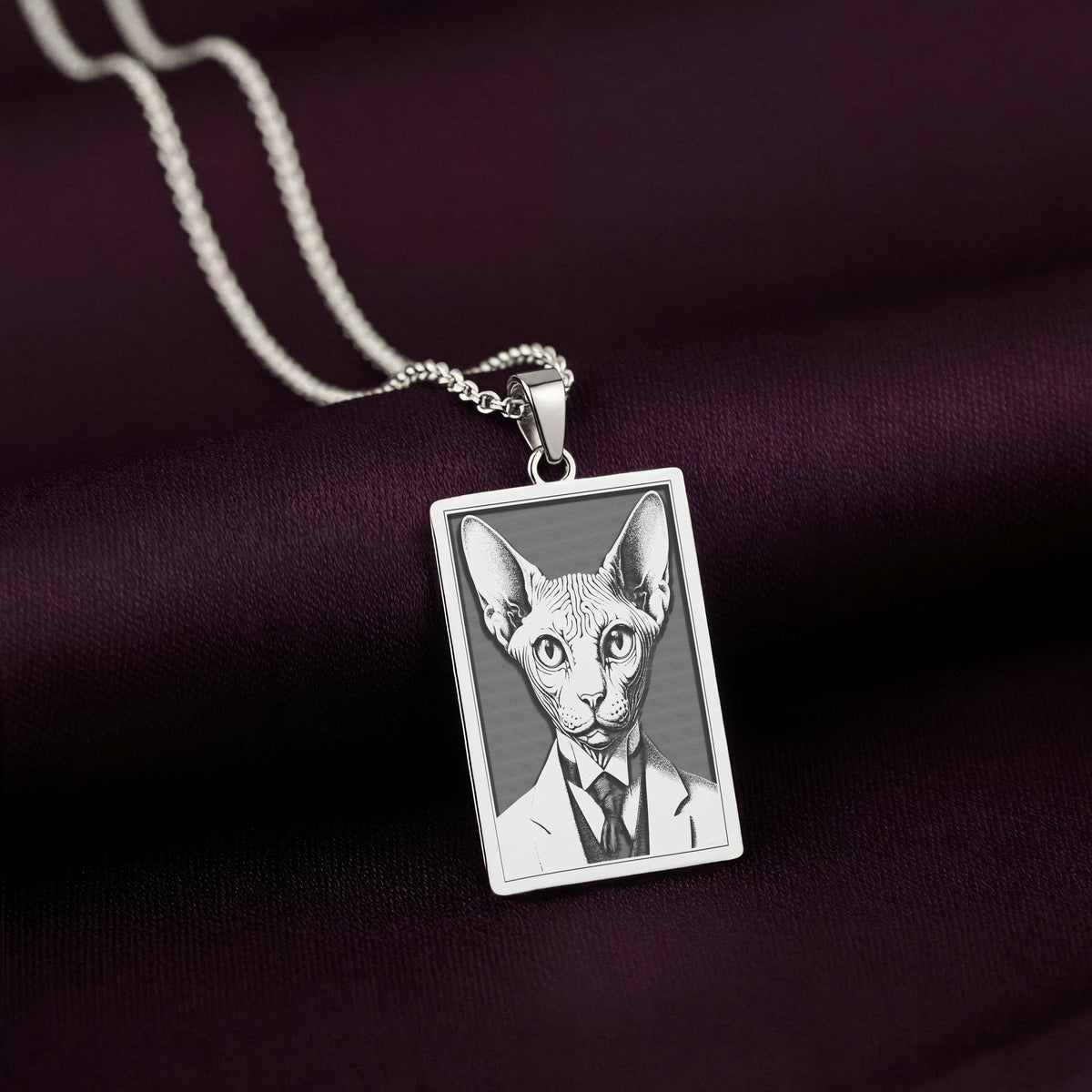 A polished 925 sterling silver rectangle pendant with a custom laser-etched portrait of a Sphynx cat in formal wear. A perfect cat dad gift.