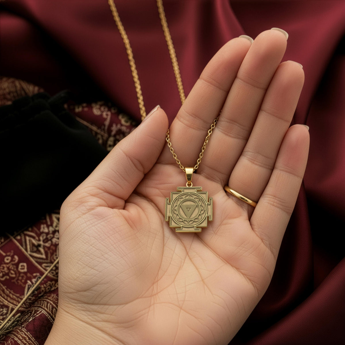 MahaKali Yantra rose gold pendant - back detail showing hand