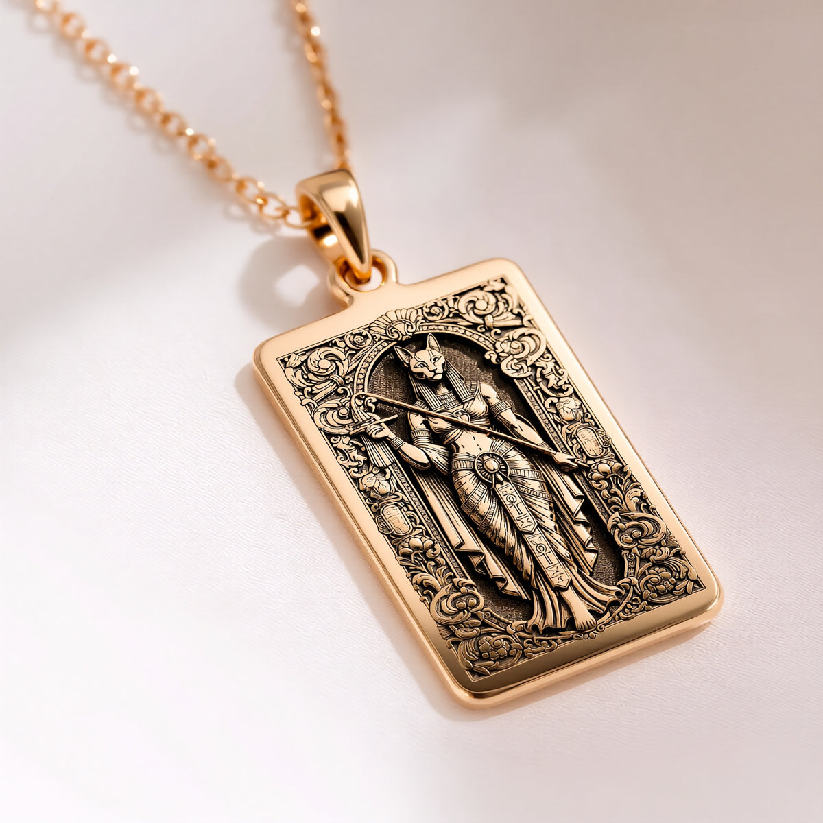 An heirloom-quality 14K solid gold tarot card amulet depicting the Goddess Bastet. This fine engraved jewelry is a sacred Kemetic paganism symbol.
