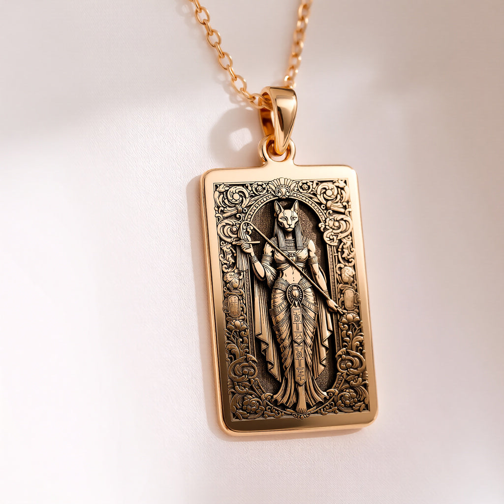 An heirloom-quality 14K solid gold tarot card amulet depicting the Goddess Bastet. This fine engraved jewelry is a sacred Kemetic paganism symbol.