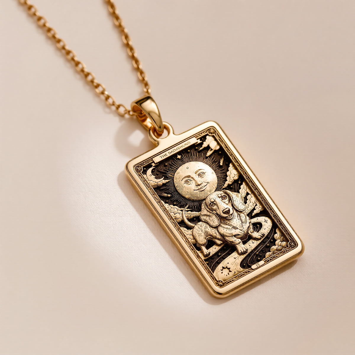 An heirloom-quality 14K solid gold Dachshund tarot pendant. The art shows the dog in a "Sun" card, symbolizing a sunny personality, a precious dog mom gift.