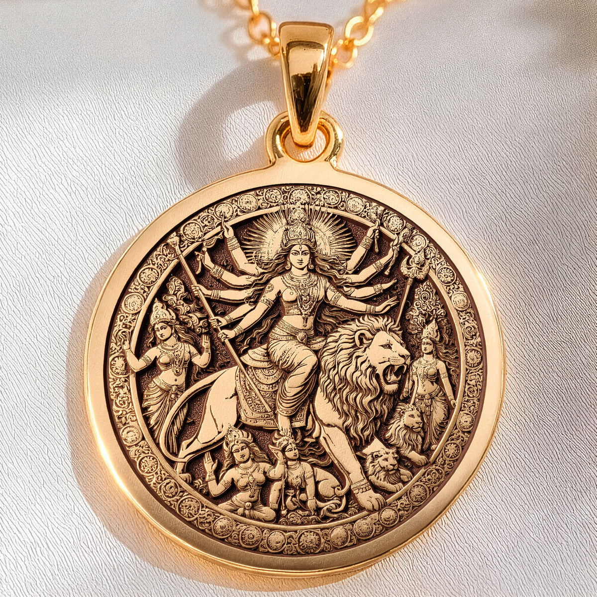 Durga Warrior Goddess Pendant Necklaces 14K 14K Gold Plated pendant featuring a circular relief of a mythological female figure with a lion and surrounding figures.