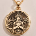 Harmonia Goddess Medallion pendant in 14K solid gold showing front view with floral crown, crossed hands, starry border.