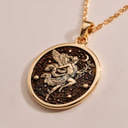 Hermes Medallion Pendant Necklaces Rose 14K Rose 14K 14K Rose 14K 14K Rose Gold Plated round pendant with winged figure design on dark fabric.