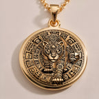 An elegant rose gold plated tarot card pendant depicting a jaguar portrait. This engraved piece is a tribute to Mayan and Aztec mythology, a perfect piece of wearable art.