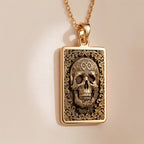 Skull & Bones Memento Mori Pendant Necklaces Yellow gold skull pendant with ornate scrollwork necklace