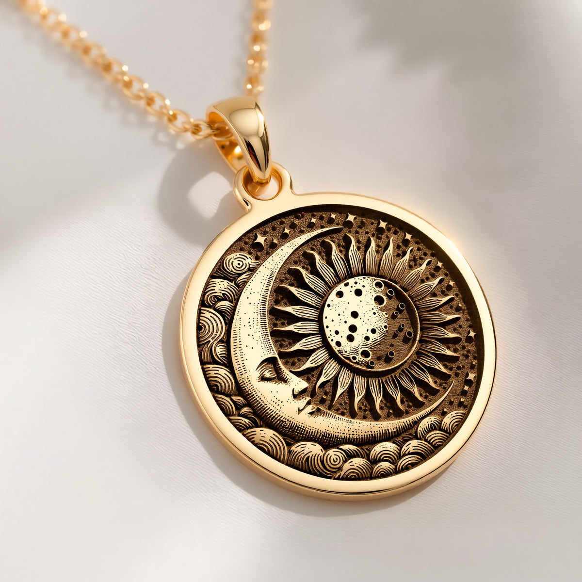 A gold necklace with a round pendant featuring a celestial sun and moon design. The intricate details symbolize harmony and cosmic balance, making it a perfect accessory for lovers of unique, symbolic jewelry. Ideal for both daily wear and special.