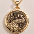 Peacock Mandala Bird Pendant Necklace in 14K gold showing front view with engraved peacock, mandala, sun, moon and stars.