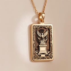 Polished 14K solid gold Phoenix Rising Rebirth charm necklace. Spiritual protection symbol jewelry for rebirth.