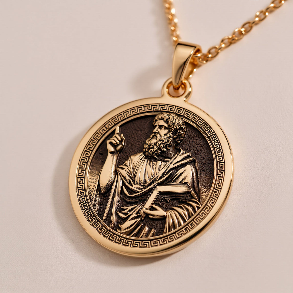 A polished 14K solid gold Plato pendant. This fine jewelry represents the quest for truth, making it a powerful gift for a student or teacher.