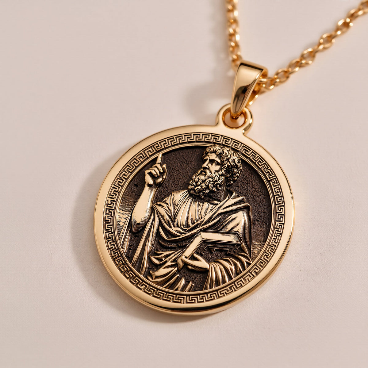 A handmade 14K gold plated Plato necklace. The engraving captures the founder of the Academy, a timeless symbol of classical thought.