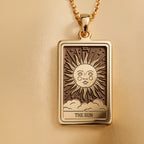 Sun Tarot Major Arcana Pendant Necklaces Yellow gold rectangular pendant of a sun with face and rays above clouds necklace