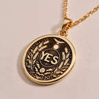 Rose Gold Plated YES Medallion featuring powerful affirmation surrounded by laurel wreath and celestial symbols. Elegant empowerment jewelry with detailed botanical and spiritual elements.