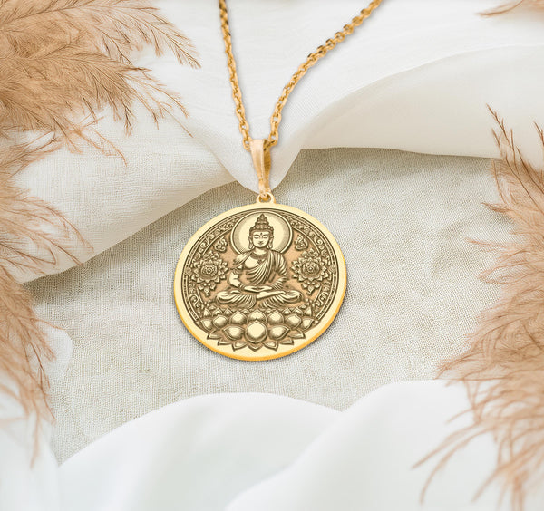 Buddha 14k solid yellow gold coin pendantfigure seated in meditative lotus pose (Padmasana) upon a blooming lotus flower base. The warm, radiant luster of the high-quality 14 karat solid gold highlights the fine craftsmanship of the central deity and the surrounding ornate floral mandala-style patterns filling the circular frame.Perfect yoga or mindfulness heirloom gift jewelry.
