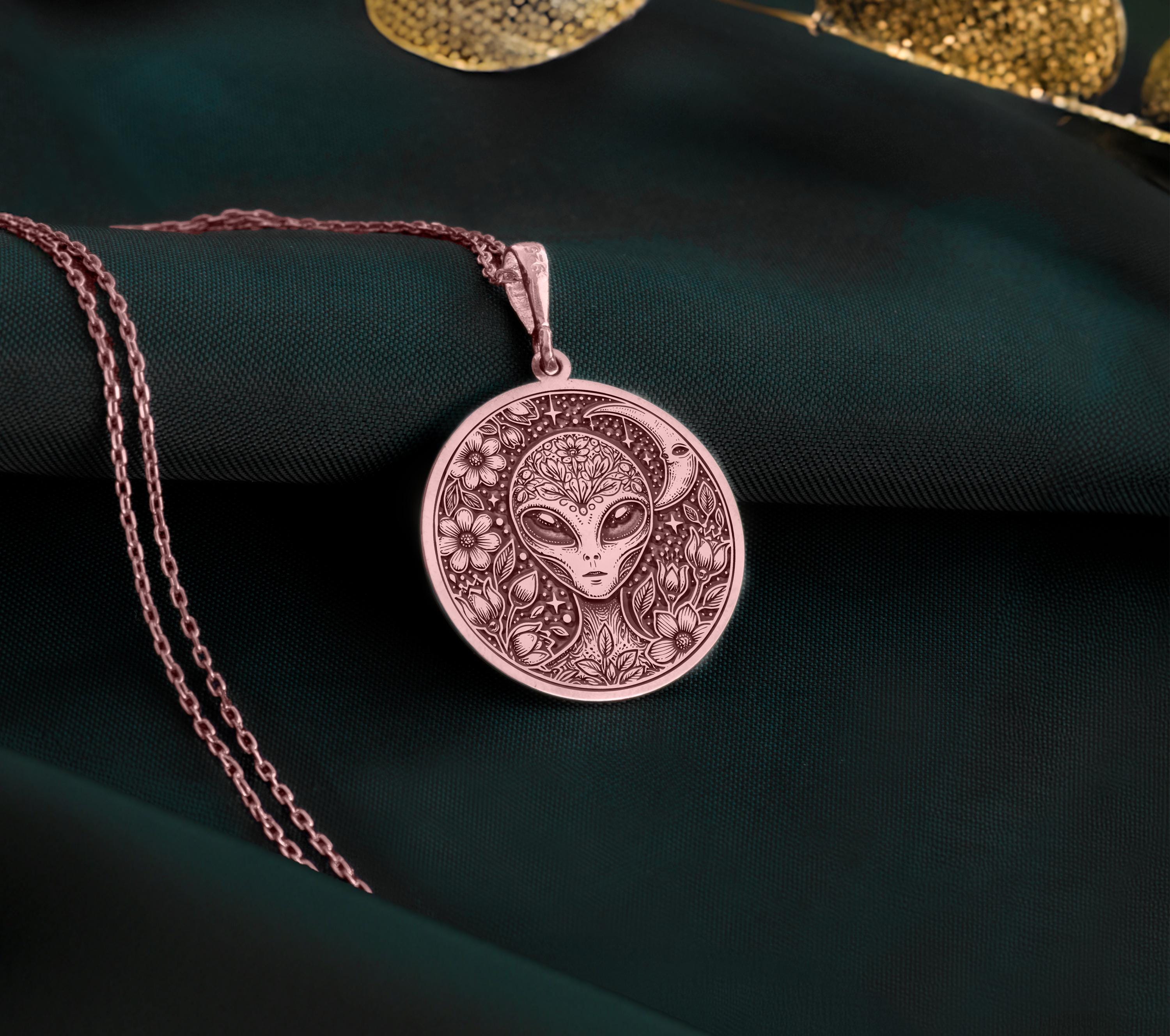 Rose gold plated extraterrestrial necklace, designed with cosmic elements and floral engravings. A stunning sci-fi medallion, ideal for space enthusiasts and those who love celestial jewelry.