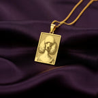 A rectangular 14K gold plated pendant necklace featuring a beautiful laser engraving of an elegant Poodle in a Victorian portrait style.
