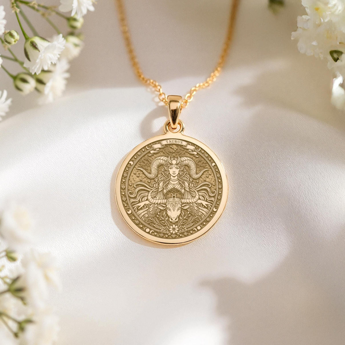 14K solid gold Taurus medallion. The art shows the bull-horned goddess, symbolizing stability, a precious April birthday gift.