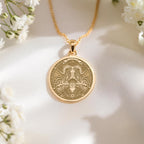 14K solid gold Taurus medallion. The art shows the bull-horned goddess, symbolizing stability, a precious April birthday gift.