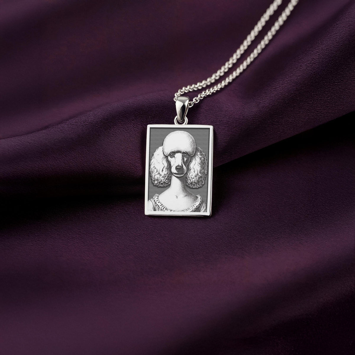 A polished 925 sterling silver rectangle pendant with a custom laser-etched portrait of an elegant French Poodle, ideal as a dog memorial gift.