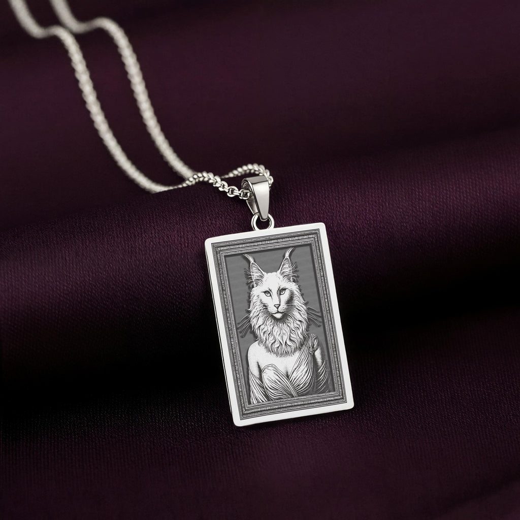 A handcrafted 925 sterling silver Ankara cat charm in a rectangular shape. This personalized piece of anthropomorphic jewelry is a standout accessory for any cat lover.