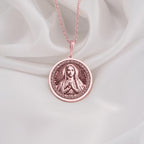 Graceful Rose Gold Plated Mary necklace featuring the Queen of Peace in prayer. A feminine and spiritual rose gold faith pendant.