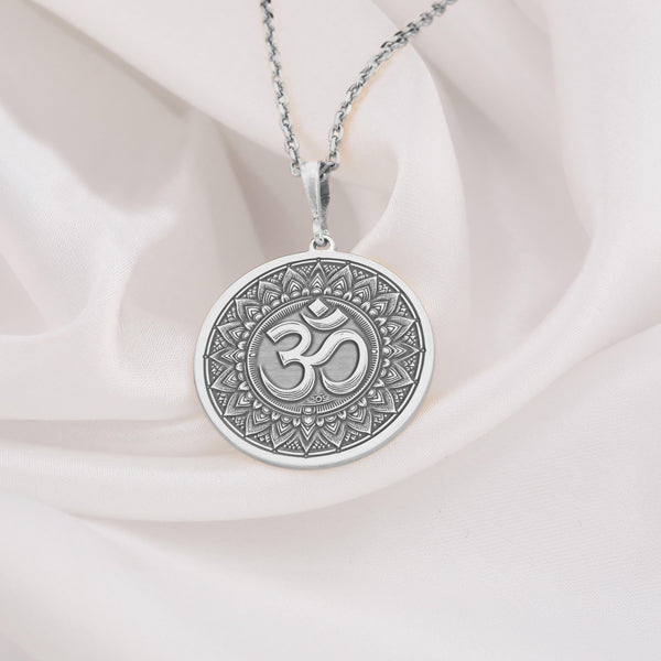 Beautiful sterling silver Om necklace with a circular pendant design showcasing a prominent Om symbol centered within decorative, spiritual motifs, ideal minimalist jewelry for everyday wear or special occasions.