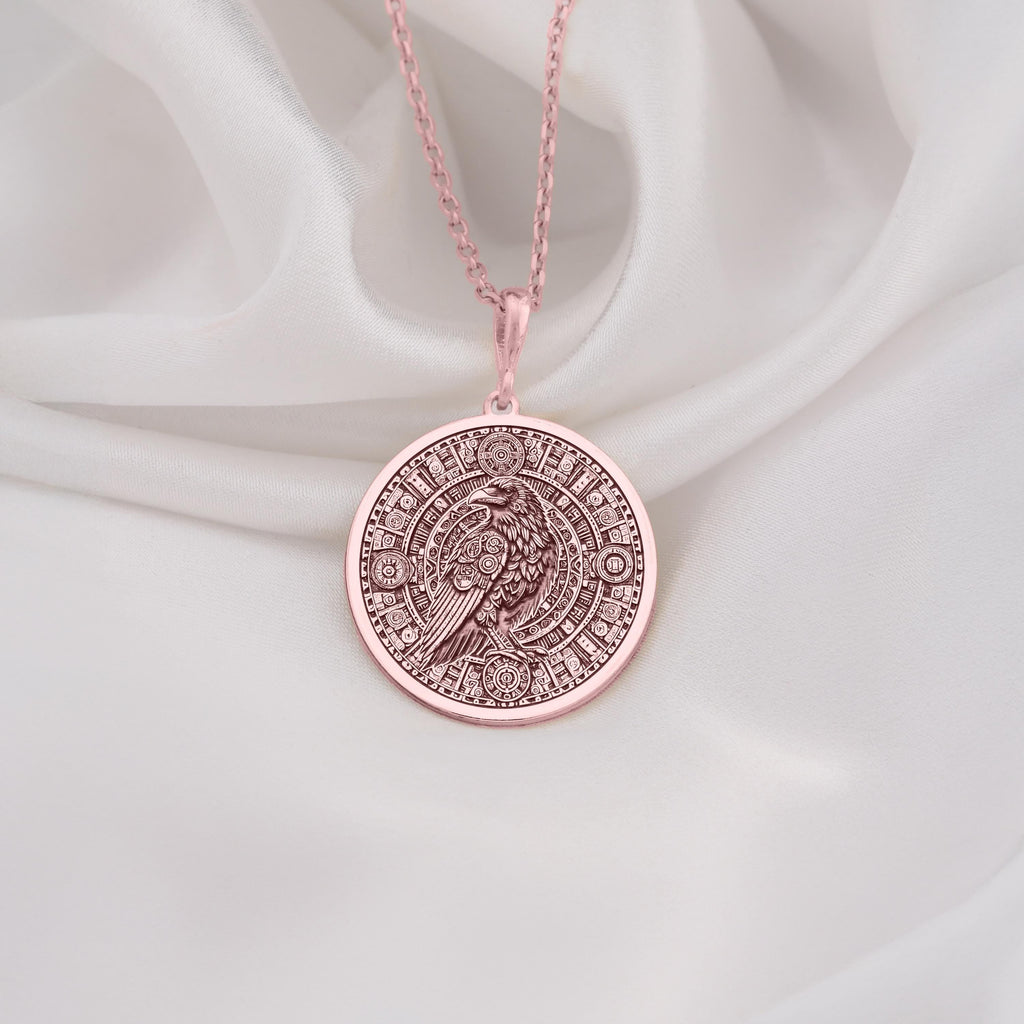 Rose Gold Plated Raven Pendant Necklace showcasing a Mayan-inspired Aztec calendar design. A meaningful jewelry gift for history and mythology admirers. A stylish accessory for any occasion.