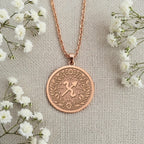 Engravable Rose Gold Plated Sagittarius Pendant. The horoscope symbol medallion with a laurel wreath is a perfect personalized gift for a November or December birthday. Customizable jewelry.