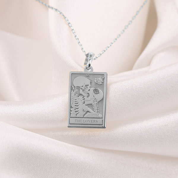 &quot;Silver &#39;The Lovers&#39; Skeleton Charm Necklace with two intertwined skeletons symbolizing eternal love. A unique gothic pendant, perfect for Halloween or romantic gifts. Silver-plated, adjustable chain. Ideal for dark, alternative fashion lovers.&quot;