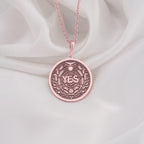 Rose Gold Plated YES Medallion featuring powerful affirmation surrounded by laurel wreath and celestial symbols. Elegant empowerment jewelry with detailed botanical and spiritual elements.